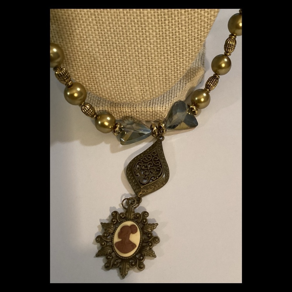 Beautiful, gold and crystal pink cameo.